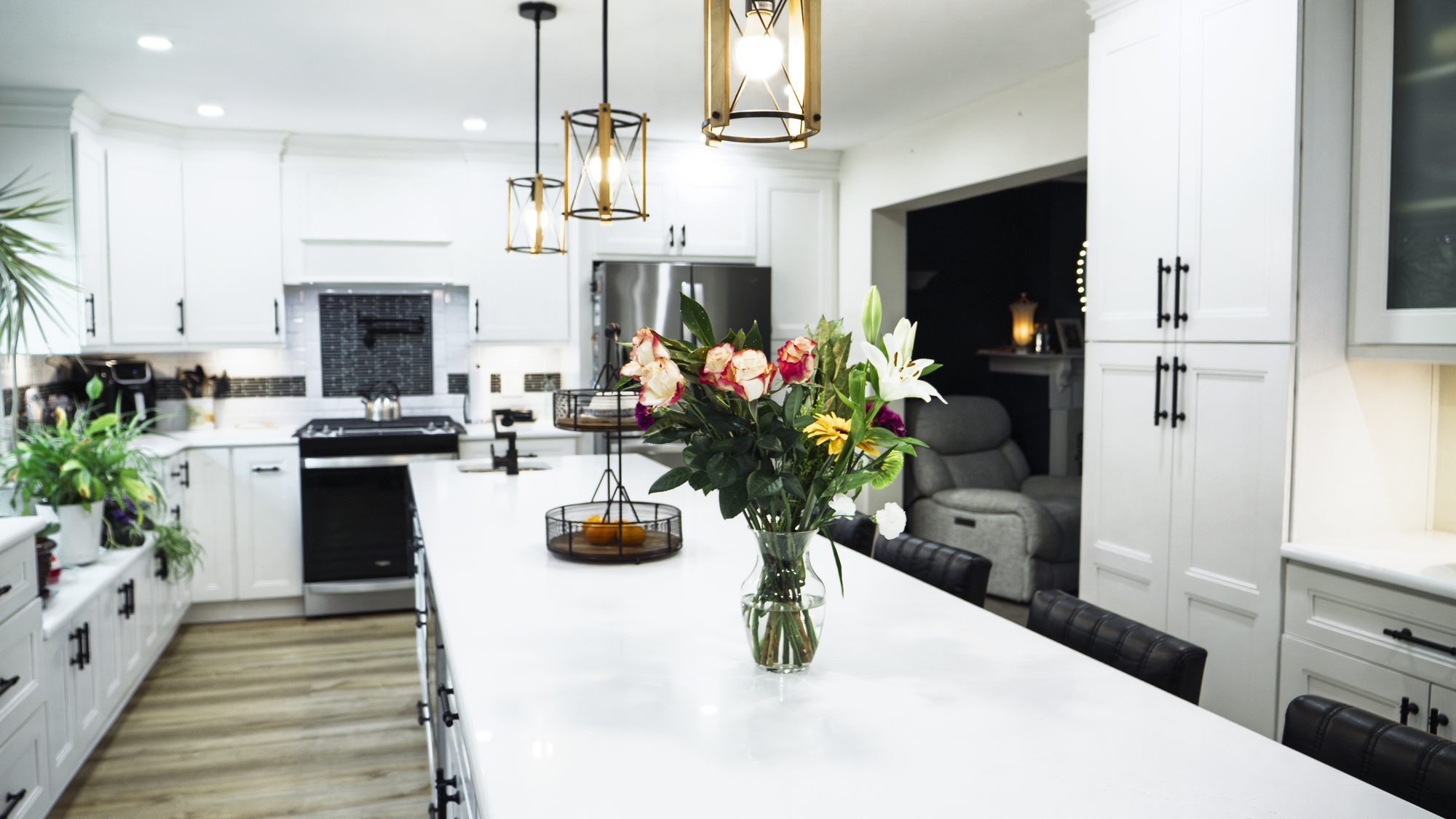 Kitchen island with flowers, living room in background